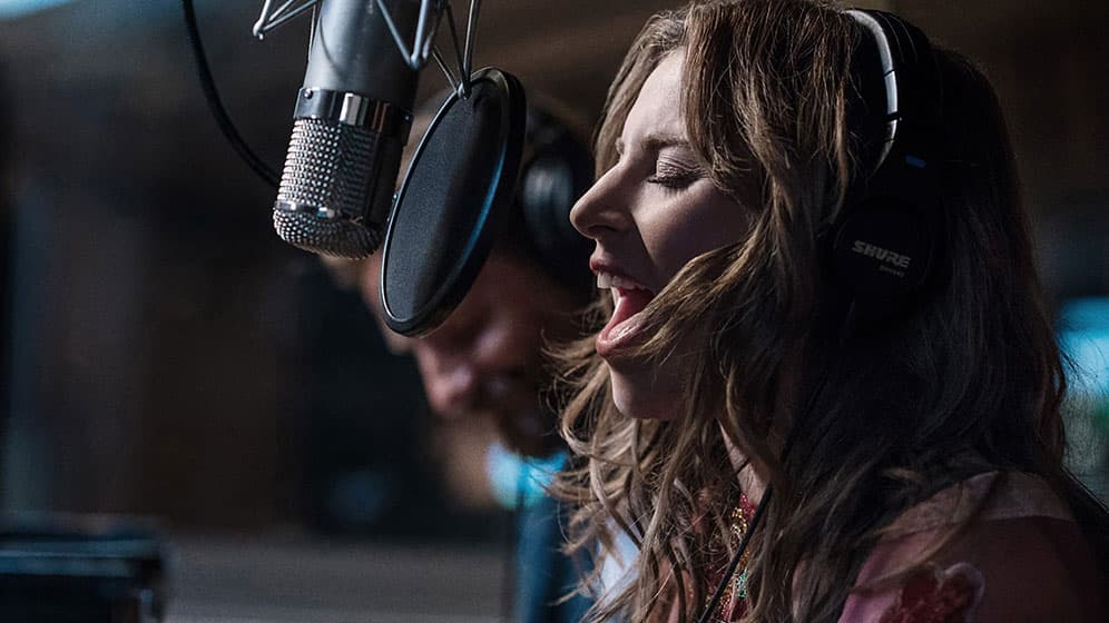 a woman singing facing the microphone